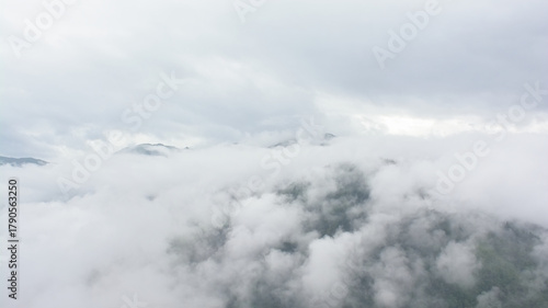 Alpine granite mountain peak covered in mist and clouds. La Vanoise national park, Savoie, France 