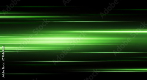 Green light trails moving horizontally across a dark background at speed