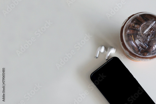 Lifestyle of a relaxing day, drinking coffee and putting down the smartphone with wireless headphones