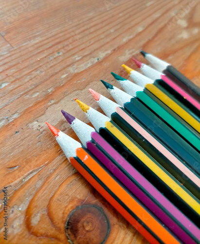 colored pencils on a wooden background
Colored pencils neatly arranged on a wooden table.