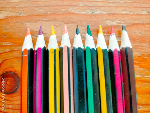 colored pencils on white background
Colored pencils neatly arranged on a wooden table.