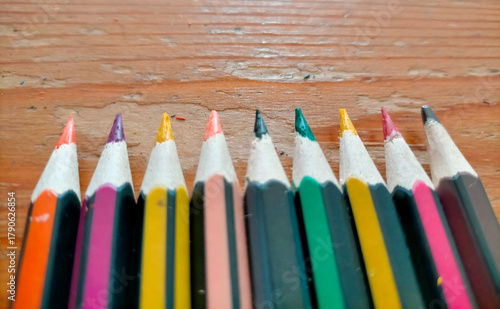 colored pencils on a wooden table