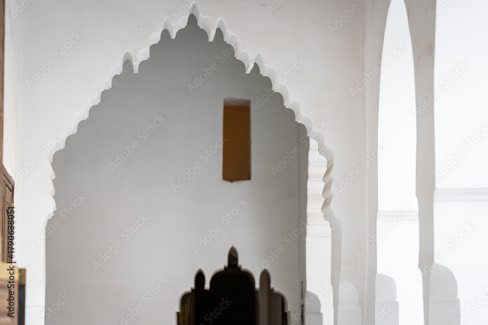 Fototapeta premium Ornate entrance arch and doorway inside the 19th century El Bahia Palace in Marrakesh, Morocco. A lambrequin arch at Bahia Palace, Marrakech. 