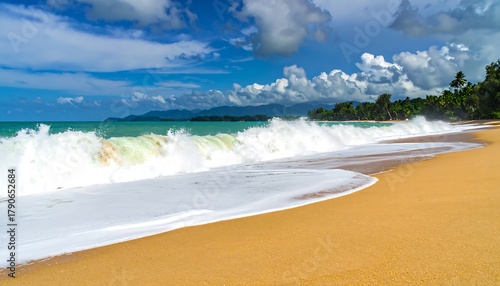 Fototapeta Naklejka Na Ścianę i Meble -  Waves crashing on a tropical beach with golden sand.