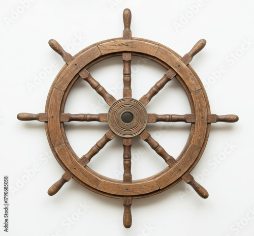 Ship wheel hangs on white wall