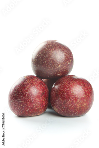 Fresh Red Plums with Speckled Skin Stacked on White Background - Healthy Organic Fruit