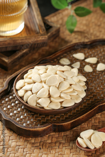 Sliced Blanched Almonds in Wooden Spoon on Rustic Bamboo Tray - Healthy Nut Snack Food Ingredient