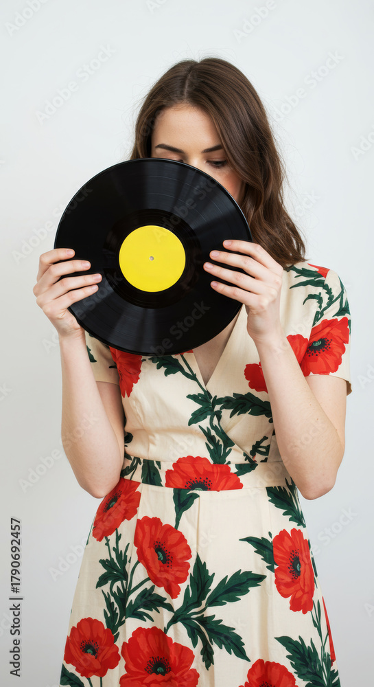 Obraz premium Woman hides face with record in studio portrait