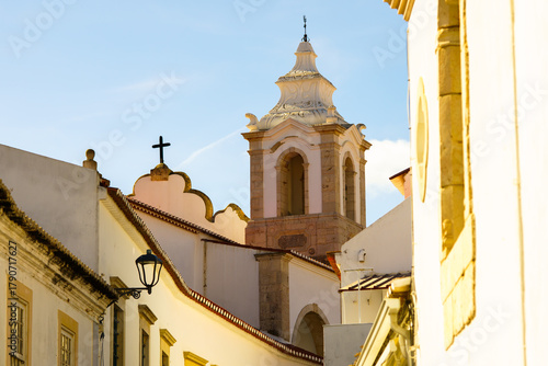 Canvas Print Church tower rises above old town buildings