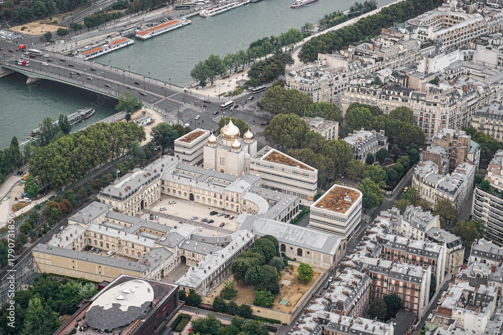 Fototapeta premium An aerial view of a part of the city of Paris, showing an Orthodox Christian church The church has golden domes, and the streets and the river are visible
