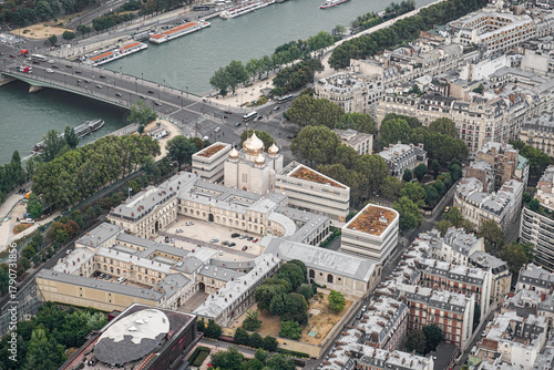Fototapeta Naklejka Na Ścianę i Meble -  An aerial view of a part of the city of Paris, showing an Orthodox Christian church The church has golden domes, and the streets and the river are visible