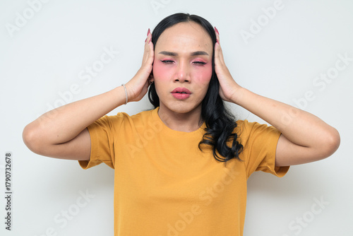 Obraz na plátně Portrait of a young Thai transgender person against white background stressed co