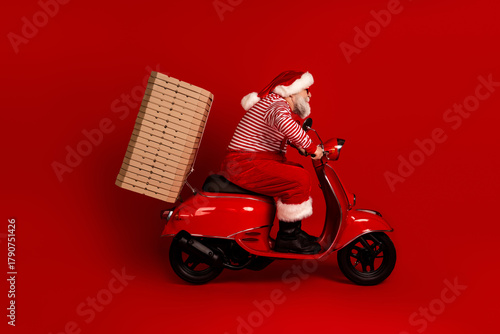 Santa rides a red scooter with a wooden crate on the back in a festive holiday scene perfect for Christmas campaigns and family friendly advertising