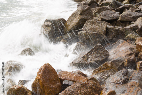 Ocean waves crashing against rocks on the shore