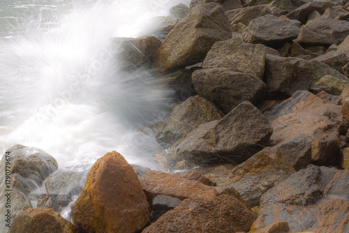 Ocean waves crashing against rocks on the shore
