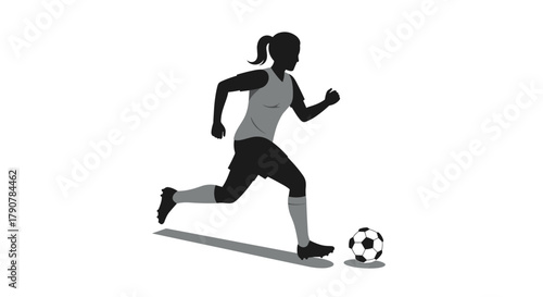 Silhouette of female soccer player kicking ball in action