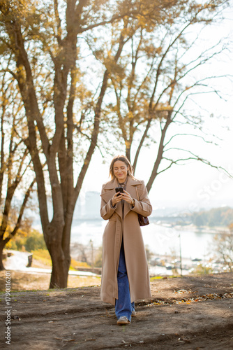 Woman in a long coat enjoyi...
