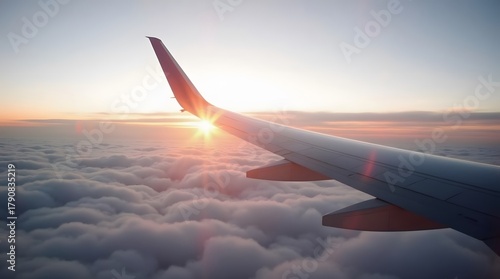 Experience stunning aerial views of sunrise from a plane wing above clouds for your travel blog