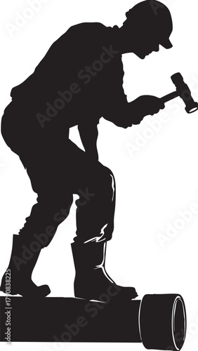 Skilled worker silhouette hammering pipe in industrial setting