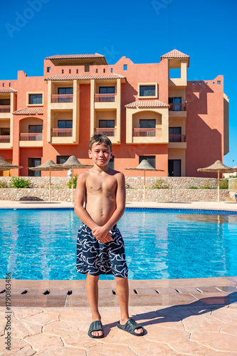 A boy near a pool at a hotel in Egypt