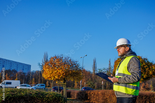 Road engineer. Studying the condition of the road surface before scheduled maintenance in the city.