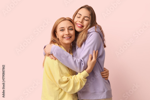 Happy young woman hugging h...
