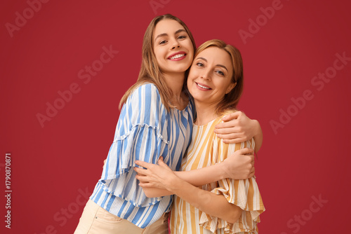 Happy young woman hugging h...