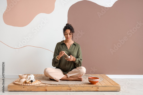 Young woman meditating with...