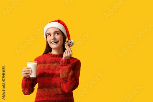 Young woman in Santa hat wi...