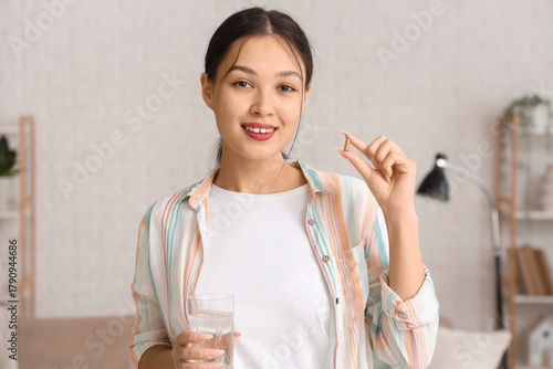 Young Asian woman with vita...