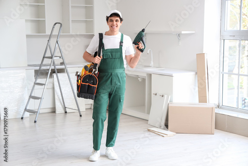 Male worker with tool bag a...