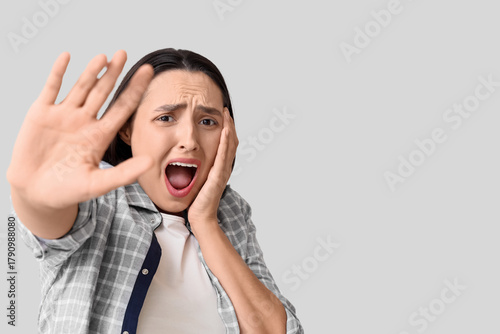 Scared young woman screamin...