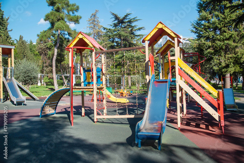 Wallpaper Mural Several slides made of yellow red and blue wood on the playground on a bright sunny day. Playgrounds, sports, health, entertainment. Torontodigital.ca