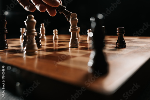 A black king advances against a white king in a decisive endgame under low key light, representing victory, pressure and strategic decision making.