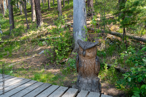 Beautiful wooden figure of owl in park Bazhovskie Places Natural Park, Sysert district, Sverdlovsk region, Ural, Russia