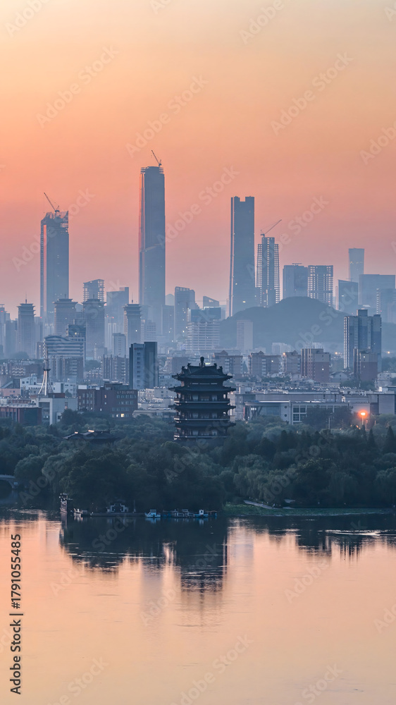 Fototapeta premium Jinan Skyline at Sunset with Traditional Pagoda and Lake Reflection, China