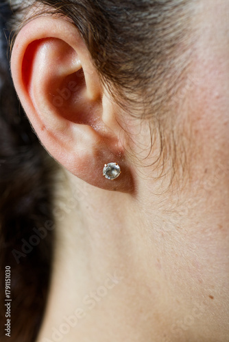 Ear with Faceted Silver Stud Earring Featuring Clear Gem Close-Up of