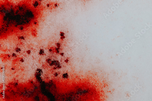 Bloody mockup. Blood on snow wallpaper.snow splattered blood. forensic blood patterns. blood droplets on icy surface. Bloody trace on snow texture.Close-Up of Red-Stained Snow Surface 