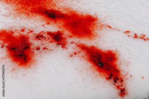 Blood on snow wallpaper.snow splattered blood. forensic blood patterns. blood droplets on icy surface. Bloody trace on snow texture.Close-Up of Red-Stained Snow Surface 