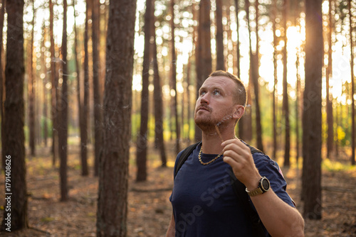 young caucasian man relaxing outdoors in the forest with incense