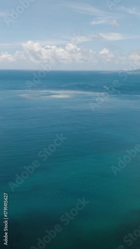 Open sea with calm surface and clear horizon under blue sky and clouds. Siargao, Philippines.