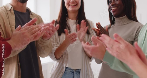 Midsection shot of a group of happy friends applauding and celebrating a holiday party at home. Laughing and having fun, showcasing friendship and joy in a festive and cheerful gathering.