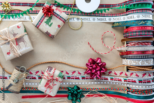 Various gift wrapping materials on brown paper with copy space in the middle.