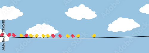 Eine Gruppe von Vögeln sitzt auf einer Stromleitung vor einem blauen Himmel mit Wolken.