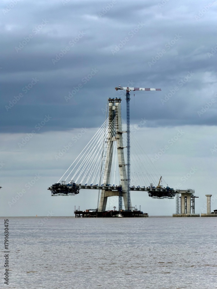 Fototapeta premium Cable-Stayed Bridge Under Construction Over River