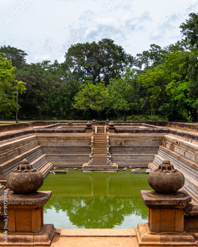 Bild auf Leinwand Symmetrical View of the Ancient Kuttam Pokuna Twin Ponds with Ornate Stone Urns