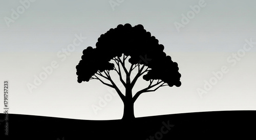 A solitary tree silhouette stands against a gradient sky, its branches reaching out in stark contrast, creating a simple yet powerful natural image