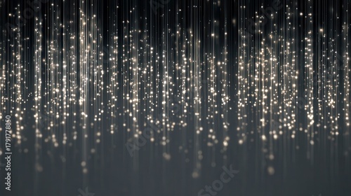 Glistening vertical lines of silver glitter fall gracefully, creating a stunning and enchanting display against a dark background in a festive setting