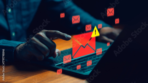 Cybersecurity concept showing a person receiving phishing or spam email alerts on a laptop. Symbolizing data breach, email security risk, online scam detection, and protection against cyber threats.