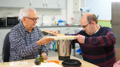 Two men with physical disability cooking in an inclusive kitchen